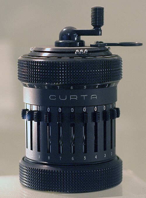 A Curta Type II mechanical calculator: a dark metal cylinder about the size of a pepper grinder, with a crank on top and numbered setting sliders down its side.